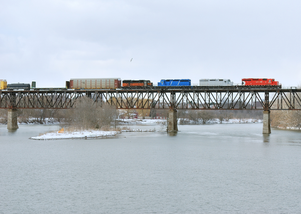 CP 240 Crossing the Grand River with a colourful consist which includes a SOO Bandit