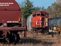 The crew's all set to go as the brakeman stands guard at the switch to allow the 4784 out before lining it back to normal for the runaround, then they run around their train and shove out the east end of the yard for the Burford Spur. 