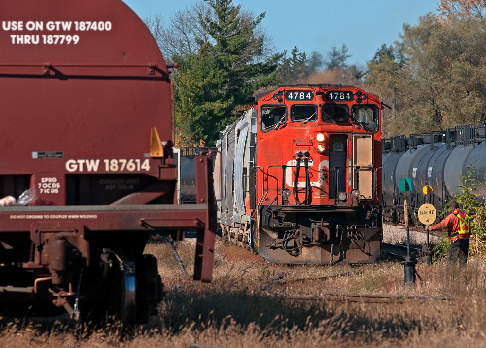The crew\'s all set to go as the brakeman stands guard at the switch to allow the 4784 out before lining it back to normal for the runaround, then they run around their train and shove out the east end of the yard for the Burford Spur.