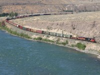 A CN eastbound freight rolls along the banks of the Thompson River