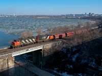 Looking south at Hamilton's skyline, train 509 heads east along the Oakville Subdivision to Mac Yard.