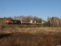 CN 107 - CN 5754 North catches a glimpse of the setting sun on the approach to Boyne. 