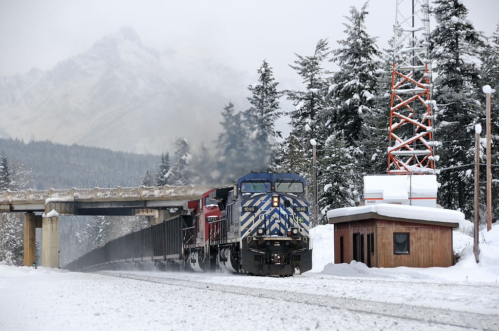 Leaving Golden, BC, westbound sulphur train 603 rolls under the Trans-Canada led by CEFX 1046 and CP 9721