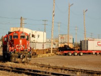 CN GP9RM's 7062 and CN 7077 switch intermodal cars in the late evening November sun at CN's Sarcee Yard in Calgary, Alberta.