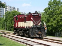 Ontario Southland (OSRX) RS23 504 backs up to couple onto its train after setting out an old wooden caboose owned by the local historical society on a rarely used spur in downtown Guelph.