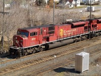 The class unit CP 9100 leads one of CP\'s hottest trains # 101. The trailing unit on this train was the 3rd to last unit in the series CP 9158. These two SD90MAC\'s have 90 cars in tow consisting of 15 autoracks followed by 75 platforms.