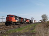 CN 385 with CN 5689 - CN 2242 - CN 2579 and 98 cars are coming around the big sweeping curve at Powerline Road that leads up to the bridge over Fairchilds Creek.