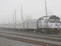VIA 70 departs Oakville behind one of the two Coors Light Silver Bullet Express Engines