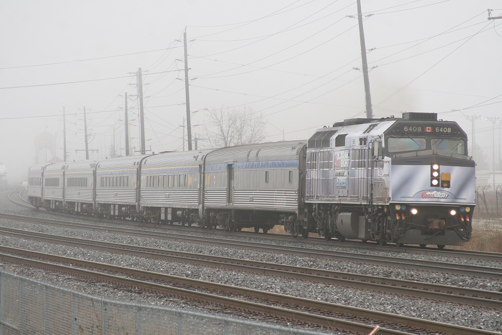 VIA 70 departs Oakville behind one of the two Coors Light Silver Bullet Express Engines