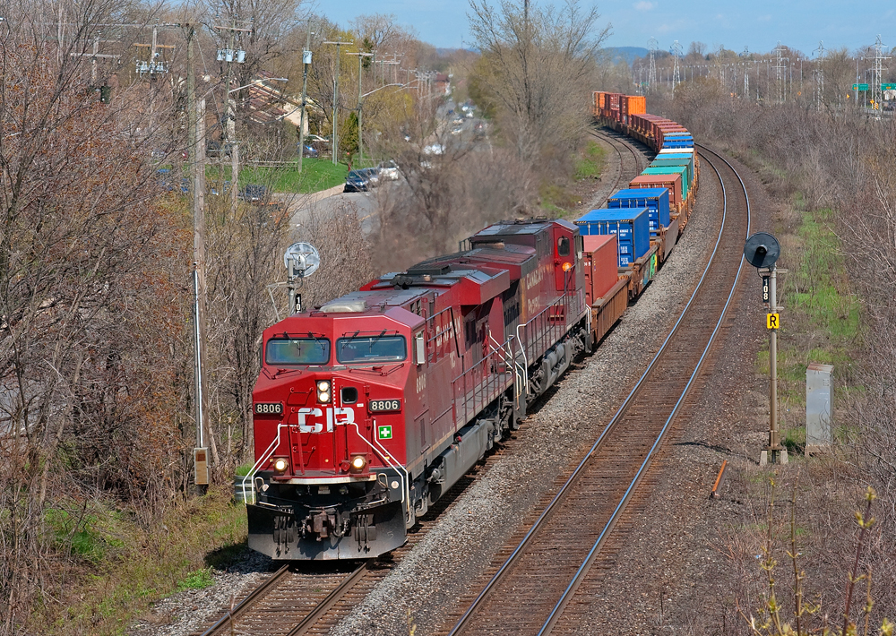 Westbound train 141 rolls though Beaconsfield on the double track Vaudreuil Sub.