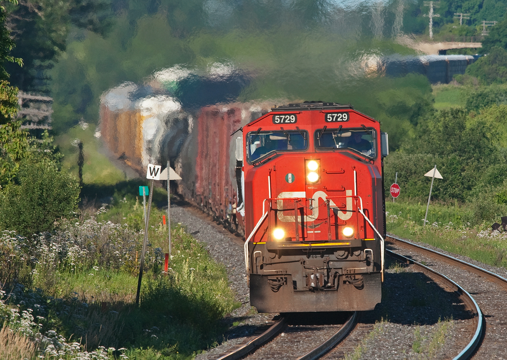 With a pair of Canadian built SD75I\'s on the head end, 308\'s train hustles east through the S-curve at Newtonville ahead of the VIA 40/52.
