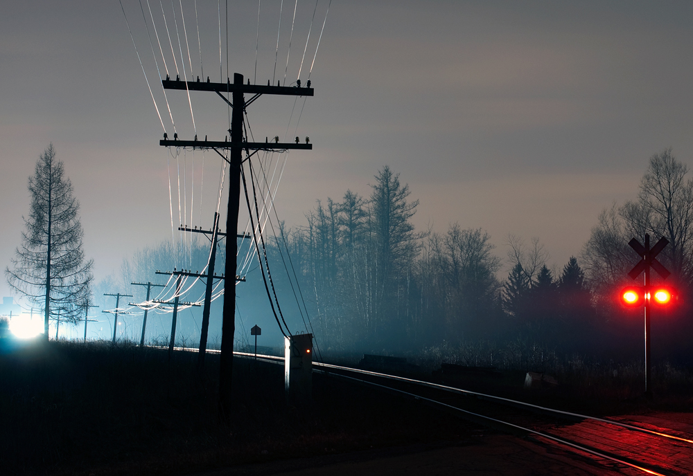 The ominous glow of an approaching freight train light up the right of way, the sound of a lone SD40-2 struggles to accelerate her train after giving up their lead SD40-2 at Vaughan.
