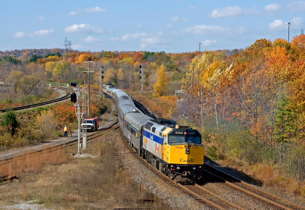 A westbound VIA train heads up the south track of the Dundas Sub in fall colours.