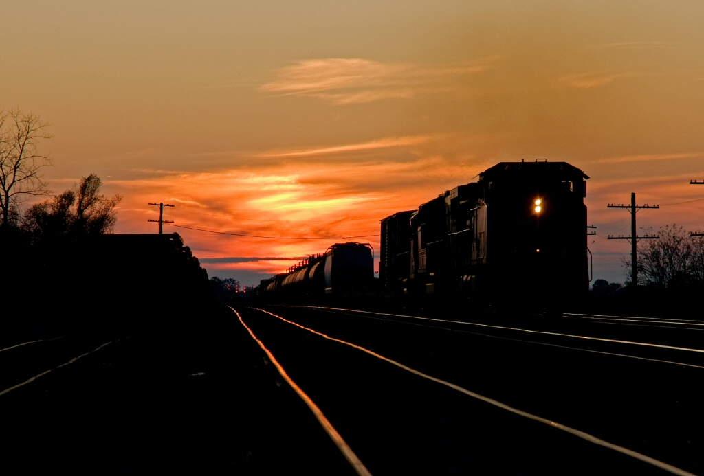An eastbound manifest charges out of the sunset in Paris, Ontario.
