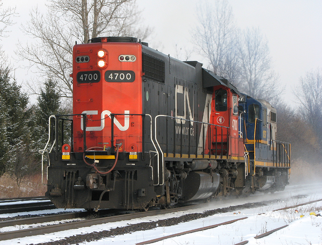 With leased CN 4700 leading long hood forward and nose-to-nose with RLK 1757, Southern Ontario Railway train 599 blasts through Copetown West at 60mph light power