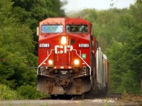 A pair of CP GE's crawling up the hill with a westbound are about to cross Main Street in downtown Campbellville, ON