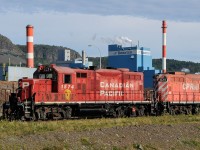 Since sidelined at the shops in Thunder Bay, CP GP9u 1574 works with sister 1629 interchanging CN revenue for empties in the "West Yard" as they work the afternoon Bowater job. In late 2009 CP went from 3 shifts a day to 2 and Abitibi-Bowater has thrown a chain link fence ultimately ruining this photo angle.