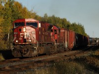 Leading a long 223 at sunset, SD90MAC 9152 and "Expressway" SD40-2 5742 power their train out of the Lakehead.