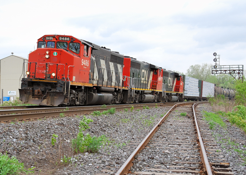 CN X411 with a trio of GP 40-2\'s makes its way past Brant Jct and the Burford Spur connection.