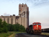 CN C772 coal loads bypasses the Canadian Pacific Westfort yard in Thunder Bay enroute to Thunder Bay Terminals Ltd, rolling under the crumbling and dilapidated Pool 11 elevator.