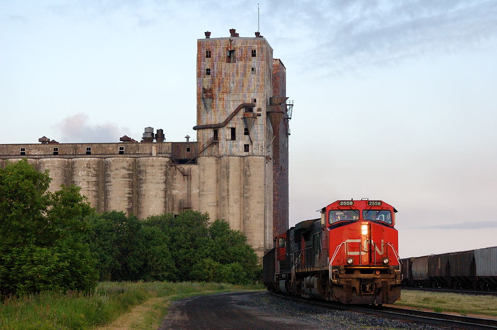 CN C772 coal loads bypasses the Canadian Pacific Westfort yard in Thunder Bay enroute to Thunder Bay Terminals Ltd, rolling under the crumbling and dilapidated Pool 11 elevator.