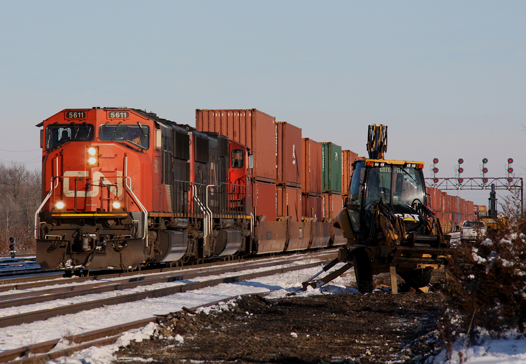 Opps! This Caterpillar backhoe looks pretty sad after picking up 3 spikes while doing bolted rail pickup in Belleville Yards