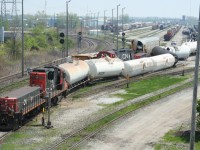 Sarnia Derailment: This was the result of a collision between two switching jobs in CN\\\'s yard in Sarnia, ON. No emergency vehicles were ever in evidence except for a single CN police truck, so I do not believe there were any injuries or leaks from any of the derailed tankcars. Sure did a good job of fouling up the west end of the main classification yard though. Fortunately the one through track at left was still available.