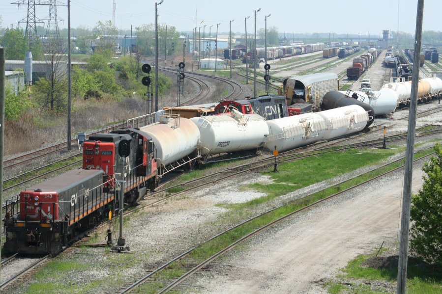 Sarnia Derailment: This was the result of a collision between two switching jobs in CN\\\'s yard in Sarnia, ON. No emergency vehicles were ever in evidence except for a single CN police truck, so I do not believe there were any injuries or leaks from any of the derailed tankcars. Sure did a good job of fouling up the west end of the main classification yard though. Fortunately the one through track at left was still available.