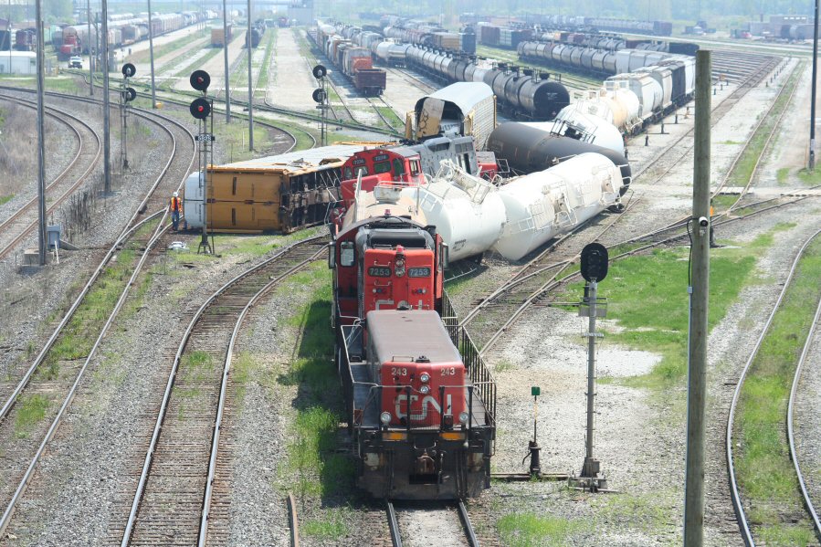 Sarnia Derailment: This was the result of a collision between two switching jobs in CN\'s yard in Sarnia, ON. No emergency vehicles were ever in evidence except for a single CN police truck, so I do not believe there were any injuries or leaks from any of the derailed tankcars. Sure did a good job of fouling up the west end of the main classification yard though. Fortunately the one through track at left was still available.