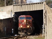 CP 426 is just exiting the tunnel that runs beneath about 6 city blocks near downtown Hamiton with CP 8603 - CP 8678 and 86 cars.