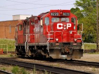 A pair of GP-9's sit in what used to be the engine service area where units could be re-fueled or turned on the turntable. The location of the former turntable pit can just be seen behind CP 8220 - CP 8207.  