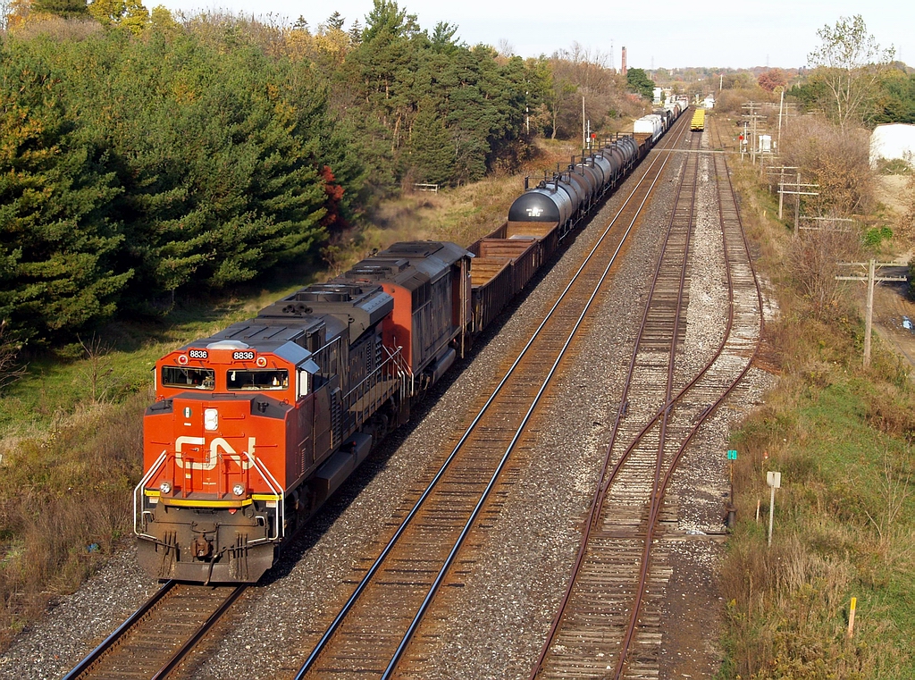 CN 331 with CN 8836 - CN 5554 lead 75 cars westbound past the west end Ingersoll Yard.