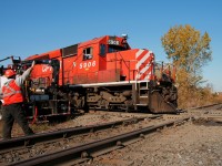 An exchange of waves between engineer and MoW foreman at the diamond while awaiting for track time from the RTC to fix a splice bar on the north track diamond, as the CP TEC train roars east at 35 MPH.