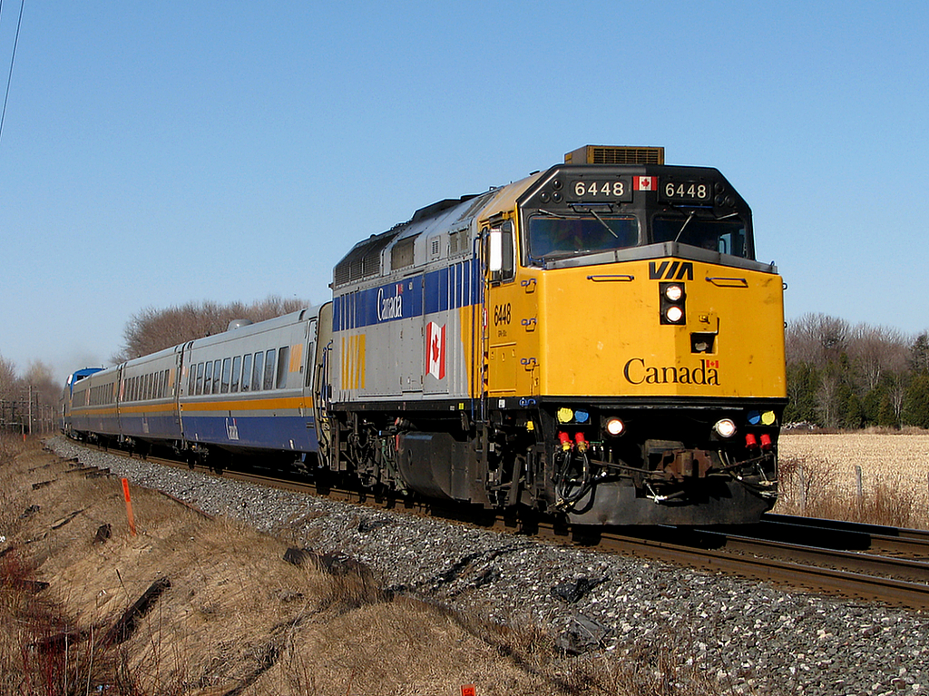 J-train 42/56 flies out of Cobourg with 6448 leading and 907 in the middle.