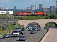 A pair of 40s roll over the morning rush hour commute of cars on the DVP, as smog continues to fill up the air in the City Of Toronto.