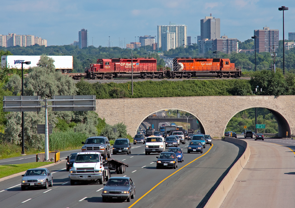 A pair of 40\'s roll over the morning rush hour commute of cars on the DVP, as smog continues to fill up the air in the City Of Toronto.