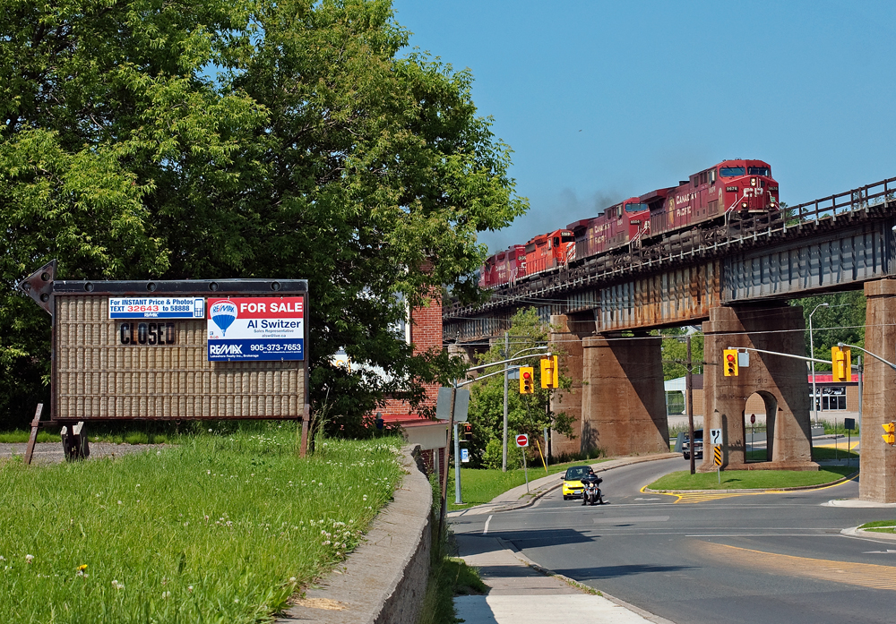 The quiet town of Port Hope plays to two main railways in Canada, Canadian National and Canadian Pacific, here we see one of the two roads in action as a pair of AC4400\'s leading an SD40-2 and a GP38-2 throttling up eastbound with a lengthy freight to Montreal.