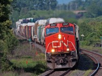 After scooping 368 on the Kingston Sub somewhere , CN 308 rounds the S curve at Newtonville with a 10,000 ft train in tow, if you look just to the upper left of the lead unit you can see the mid train remote. 