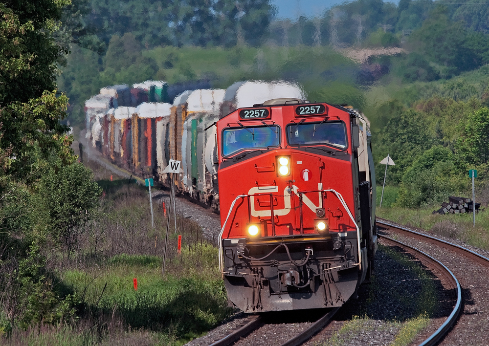 After scooping 368 on the Kingston Sub somewhere , CN 308 rounds the S curve at Newtonville with a 10,000 ft train in tow, if you look just to the upper left of the lead unit you can see the mid train remote.