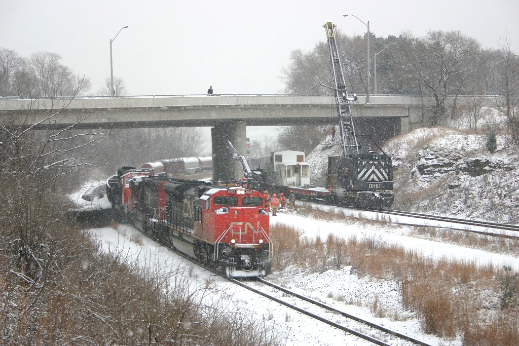 CN 331 climbs thru the Cowpath as a CP MOW crane works by the Plains Road Bridge.