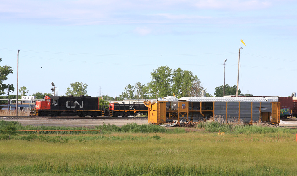 West end of A yard CN 7241 and CN 253 shove back with a cut of car\'s past the mangled autorack that was left from the derailment in Sarnia a few weeks ago.