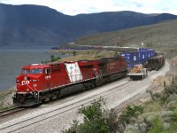 A rainshower falls on Lake Kamloops as the work train stops dumping ballast to let CP 8866 continue to the ports on the Pacific coast.