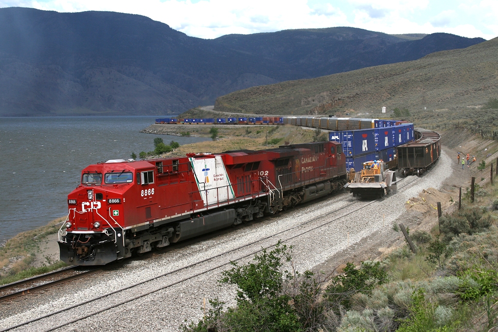 A rainshower falls on Lake Kamloops as the work train stops dumping ballast to let CP 8866 continue to the ports on the Pacific coast.