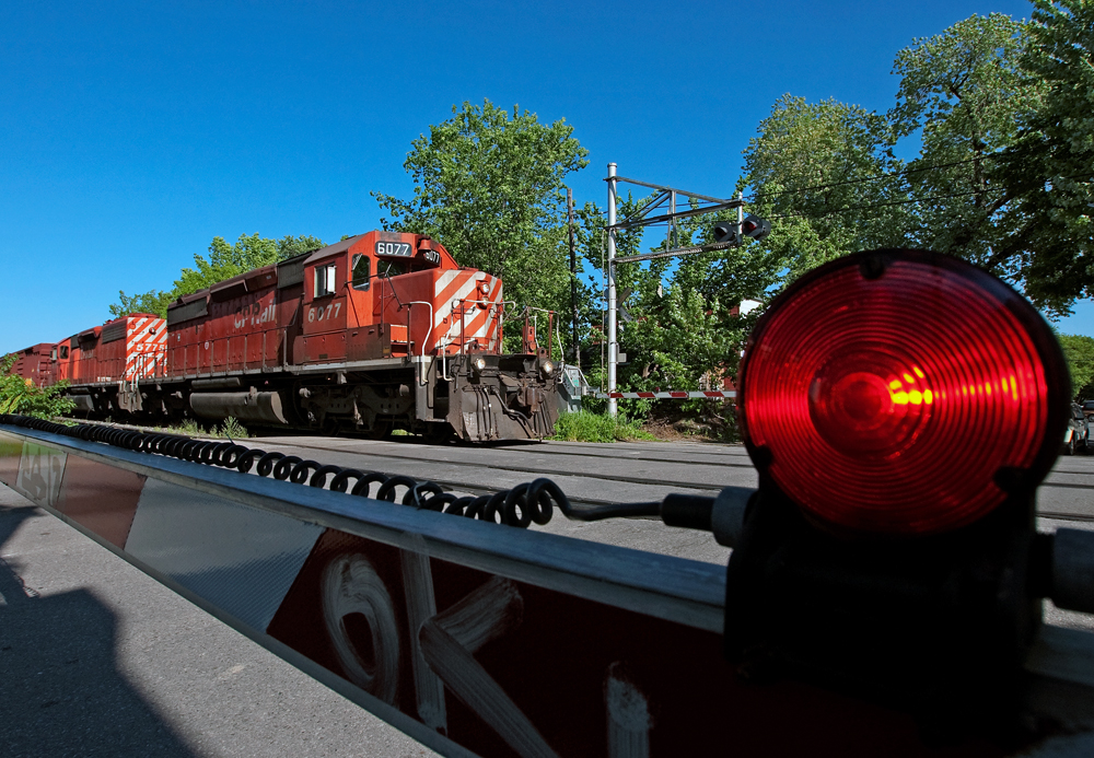A pair of action red SD40-2\'s lead a short westbound.