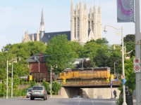 Far from home rails, Florida East Coast #709 is trailing Goderich and Exeter #432 through Guelph, Ontario past the iconic Church of our Lady, Guelph's tallest structure situated atop the highest point in town.
