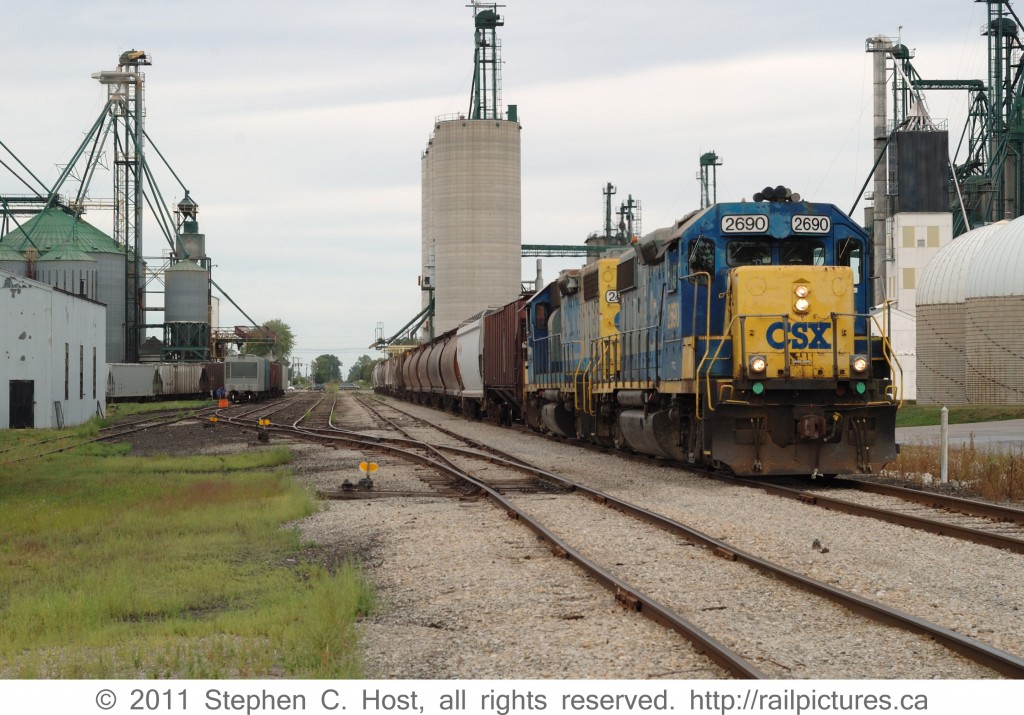 CSXT 2690 on train D724 is on the former siding of the No. 1 Subdivision at Blenheim, Ontario lifting grain traffic. The train originated earlier that day in Chatham, Ontario, and will run to Sarnia to complete a round trip servicing the Agricultural industries of Southwestern Ontario. This line has since been sold to CN.