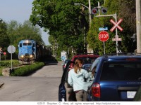 <b> Good Morning: </b> Goderich and Exeter #432 is eastbound in the morning hours as Kent. St. Residents head to work. Kent St bisects the Guelph Subdivision on either side of the railway, but is seperated from the road. In the 1850\'s when the Railway was built, Kent St was likely already established as limestone constructed homes exist here that predate the Railway.