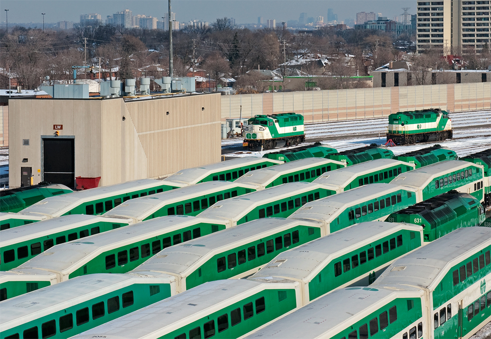 Out numbered by her successful rivals, GO 555 and her sister 556 sit across from each other, the row of MP40 in the foreground are now the normal commuter power for the trains before afternoon rush commences later in the day.