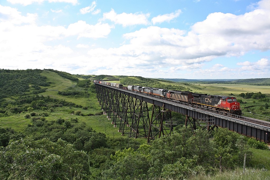 CN 403 with ex-GCFX/WC SD40-3\'s owned by JCLX are bound for Last Mountain Railway at Bethune Saskatchewan cross the Uno trestle.