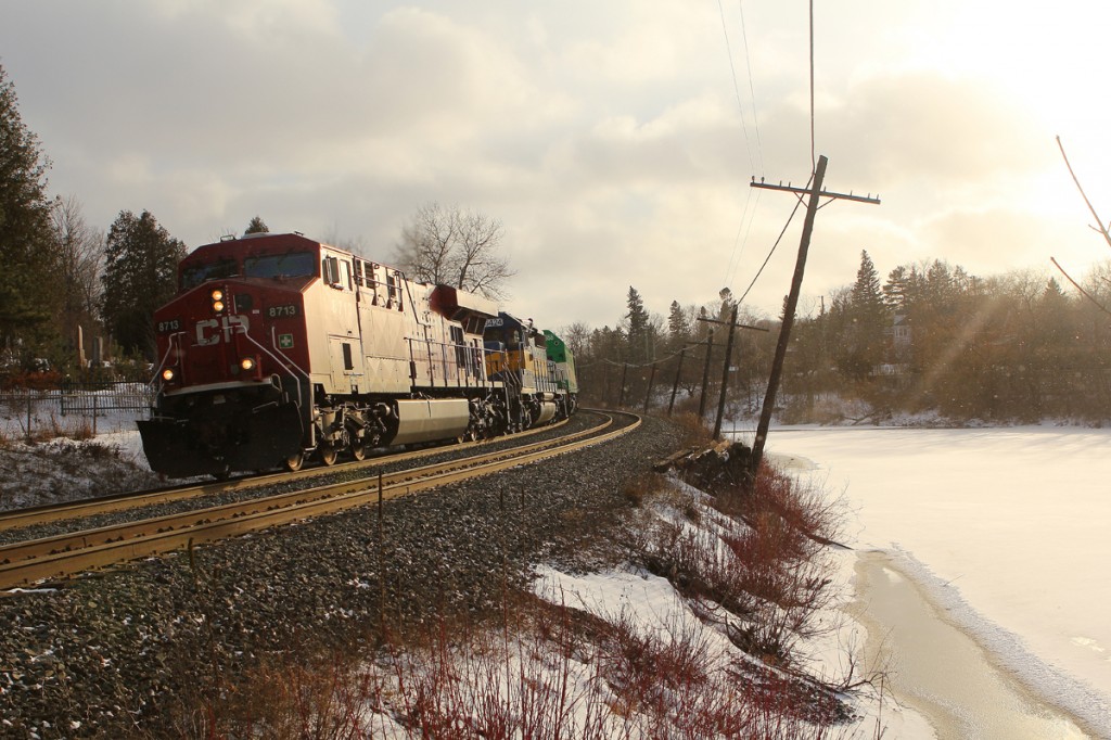 CP 242-16 leans into a curve in downtown Campbellville, ON. with ICE SD40-2 and a new GO Transit MP40PH-3C trailing.